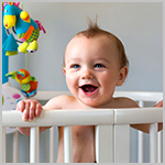 Smiling Baby in Crib