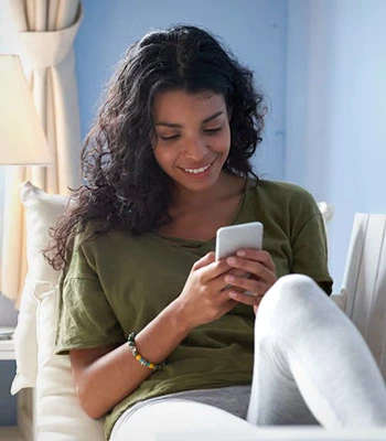 Woman texting on couch
