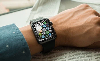 Broken Apple Watch with cracked screen on wrist
