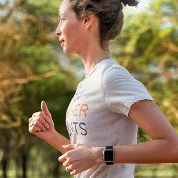 Woman running with Apple Watch