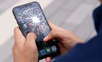 Man holding Cracked Screen iPhone