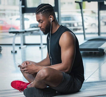 Man starting workout at gym with phone app