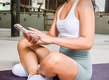 Woman starting yoga with phone