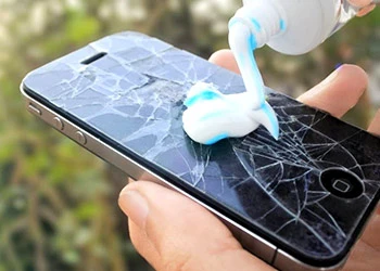 Toothpaste on a phone with cracked screen