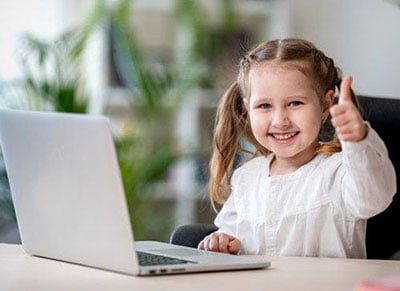 Girl using laptop on desk