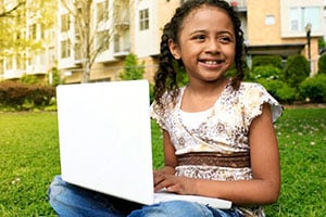Child using laptop outside