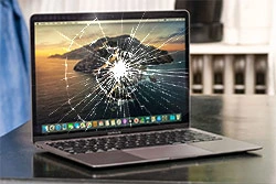 Broken Macbook laptop with cracked screen