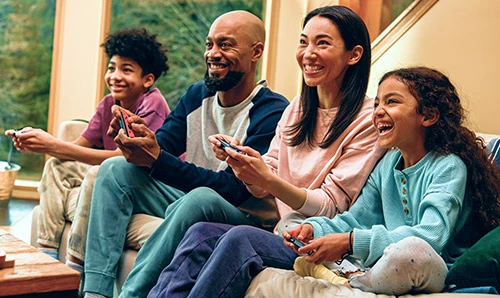 Diverse family playing Nintendo Switch game