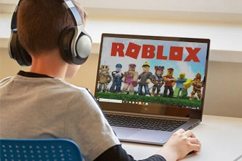 Boy playing Roblox on Laptop