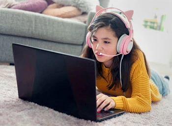Girl playing game on laptop